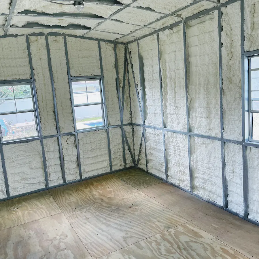 Closed-cell spray foam insulation applied to wall cavities in a residential project in Meredith